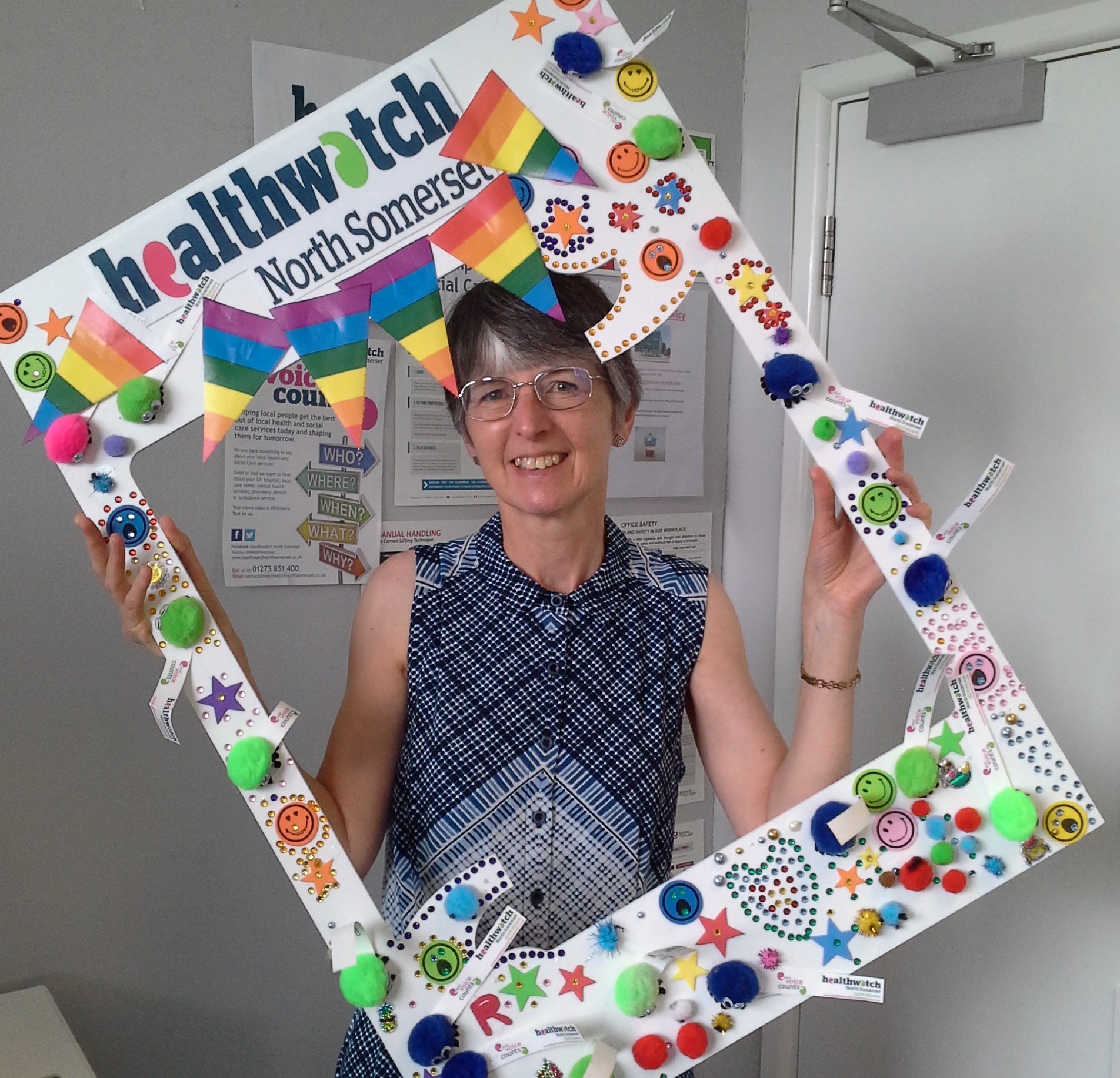 Healthwatch volunteer holding selfie frame at Pride