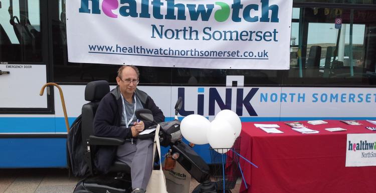 volunteer on his mobility scooter at a Healthwatch event