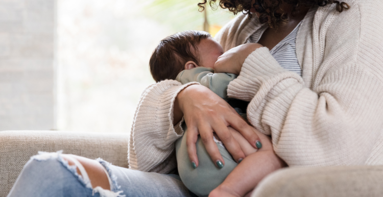A mother breastfeeding her young baby.