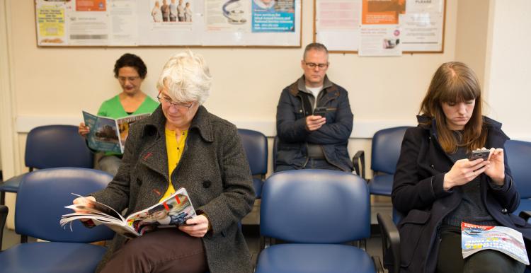 Waiting room of people looking at their phones