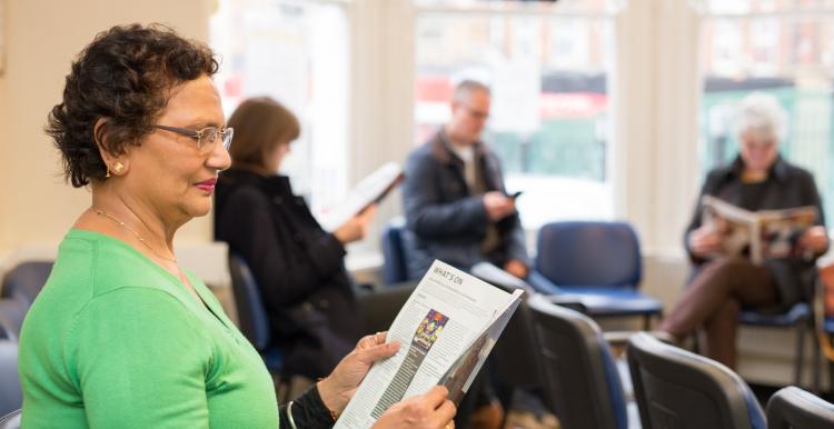 Woman reading a magazine in the waiting room
