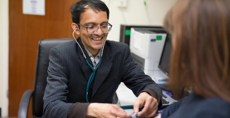 GP taking his patients blood pressure