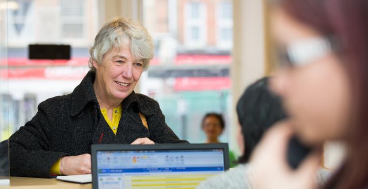 Woman talking to a receptionist 