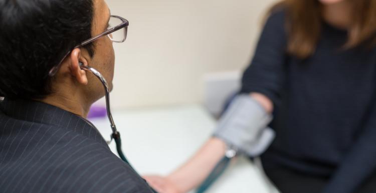 GP taking his patients blood pressure