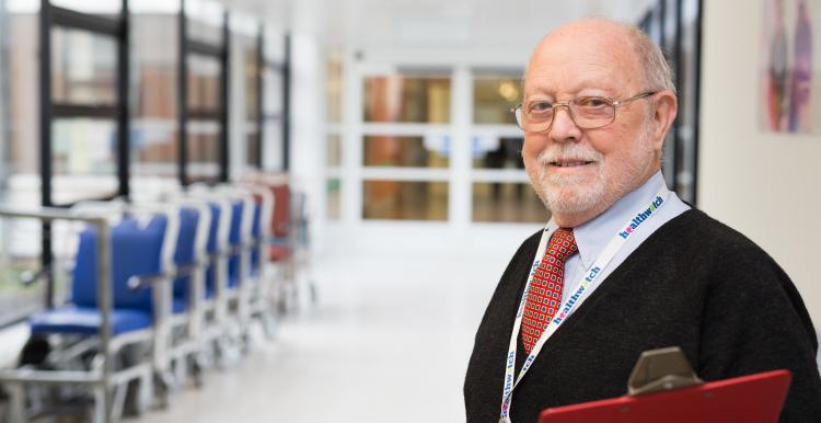 Man in a suit standing in the hospital corridor