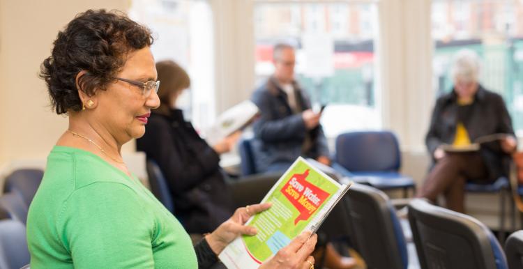 Woman sat looking at information leaflets
