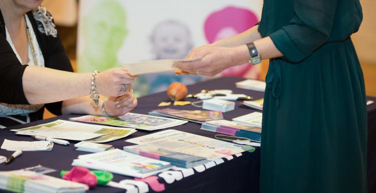 People looking at leaflets on the table