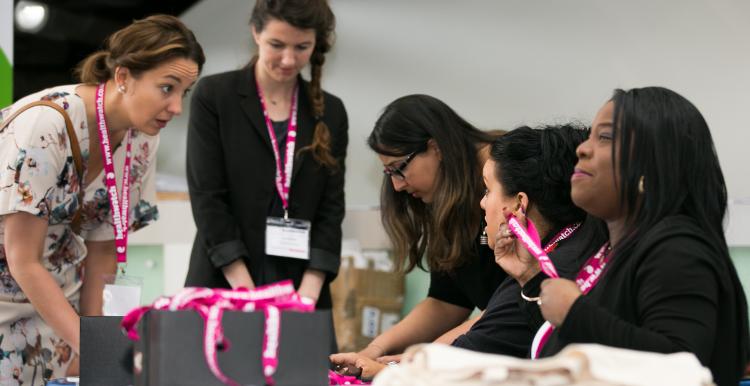 Women in a mentoring scheme having discussions over a table