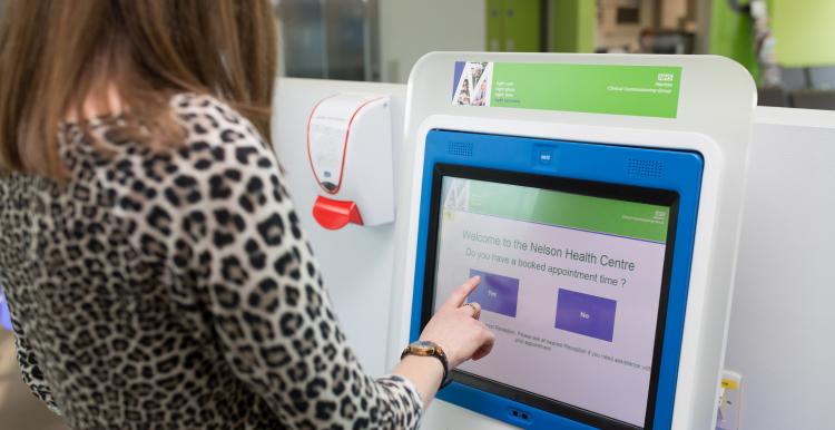 Woman using a digital screen in a health centre