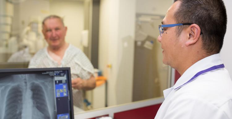 doctor looking at an xray on a computer screen
