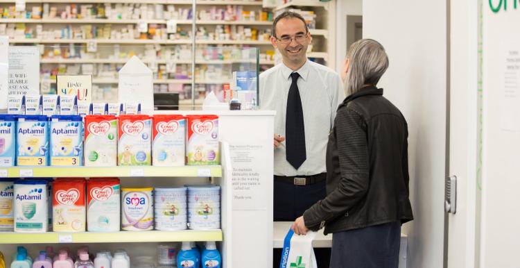 Woman talking to the pharmacist over the counter