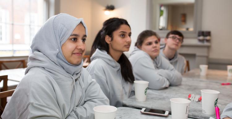 Young students sat in a row in class