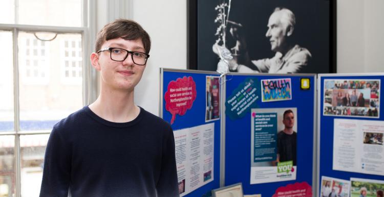 Young lad standing in front of an information board