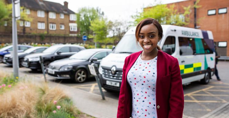 Woman standing in front of an ambulance