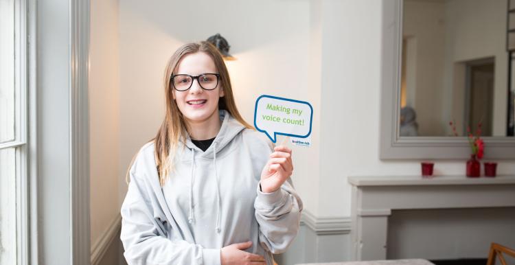 Young girl holding a sign