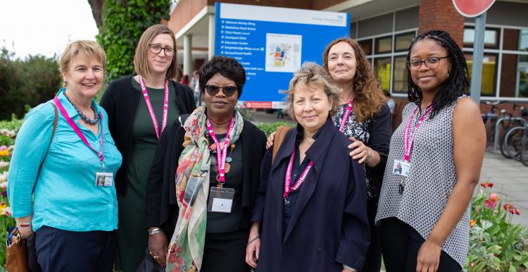 Healthwatch staff smiling in a hospital entrance 