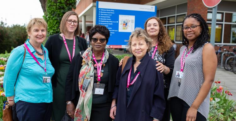 Healthwatch staff smiling in a hospital entrance 