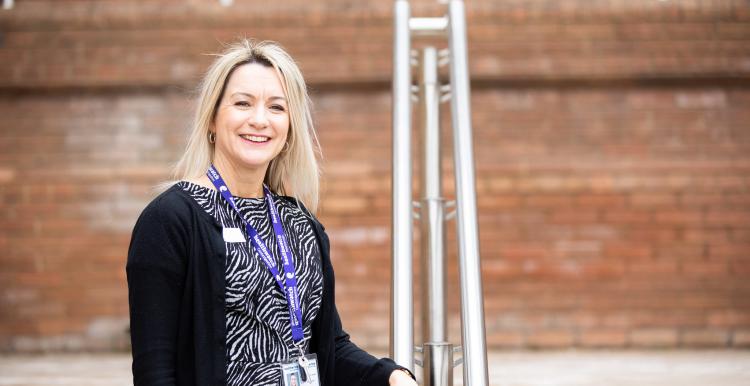 Woman stood on the steps outside a hospital