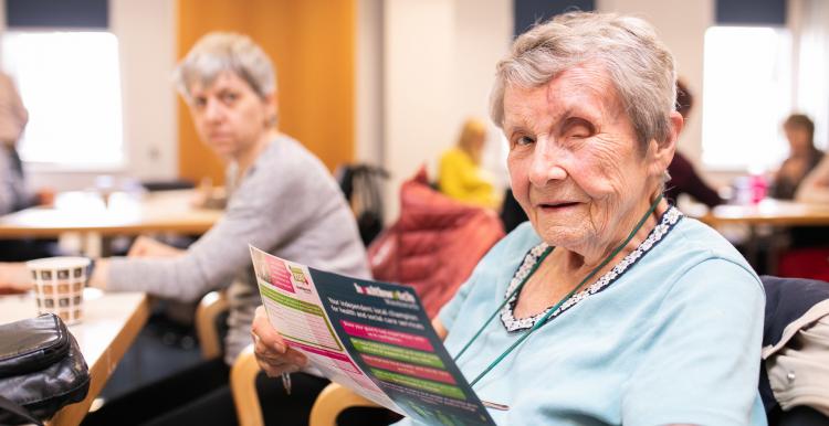 Elderly woman sitting in a canteen