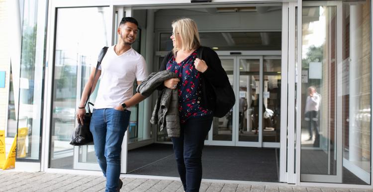 Young man and woman leaving hospital together