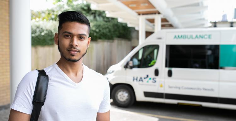 Man stood in front of a community ambulance