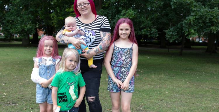 Mum standing with three children and her baby