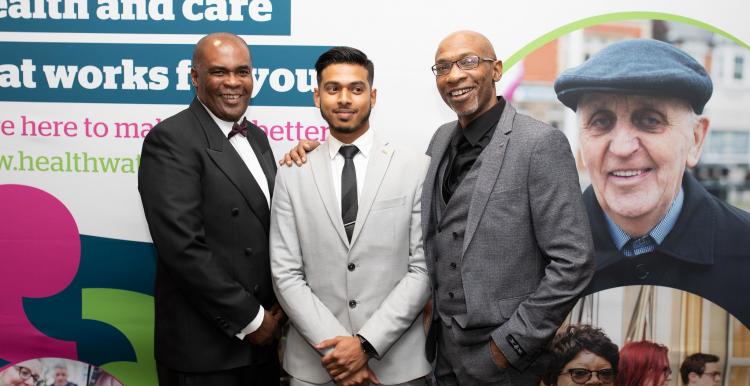 Group in front of Healthwatch posters