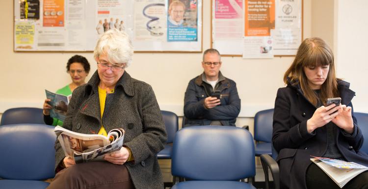 Waiting room of people looking at their phones