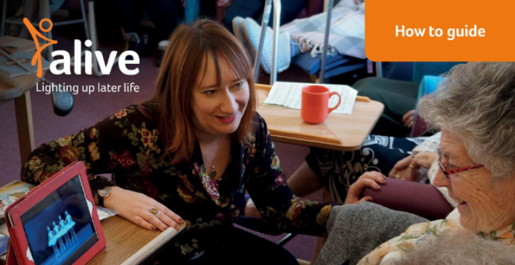 A woman supporting an older woman to use a tablet