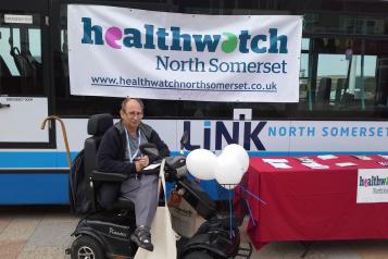 volunteer on his mobility scooter at a Healthwatch event