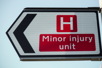 'Minor injury unit' on a road sign.