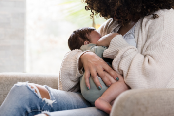 A mother breastfeeding her young baby.
