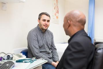 Man talking to his GP in consulting room