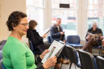 Woman reading a magazine in the waiting room