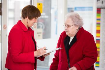 Lady taking opinions and feedback from elderly lady