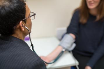 GP taking his patients blood pressure