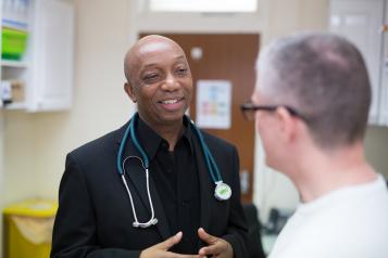 GP reassuring his patient