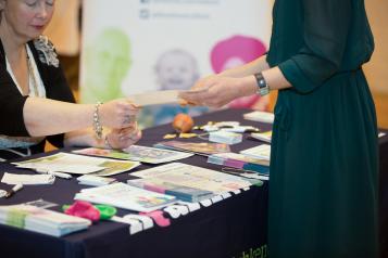People looking at leaflets on the table