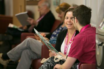 Two women sat talking over a document