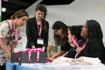 Women in a mentoring scheme having discussions over a table
