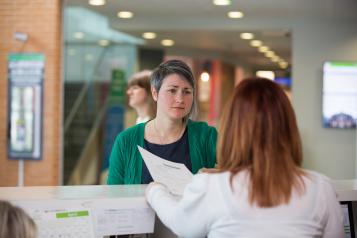Talking to a receptionist in a medical centre