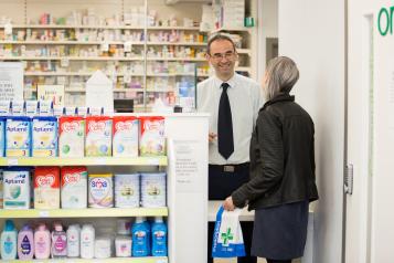 Woman talking to the pharmacist over the counter