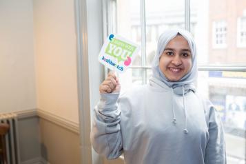 Young girl holding a sign