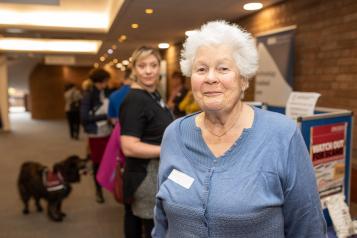 Elderly woman smiling at an event