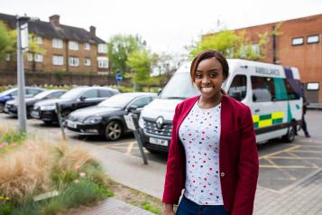Woman standing in front of an ambulance