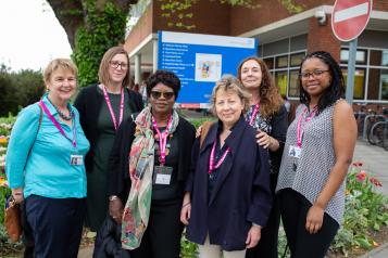 Healthwatch staff smiling in a hospital entrance 