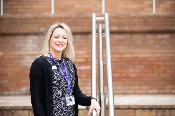 Woman stood on the steps outside a hospital