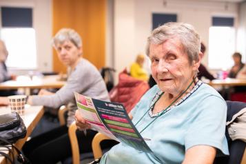 Elderly woman sitting in a canteen