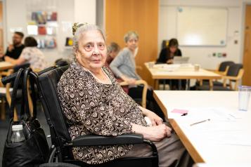 Elderly woman sitting in a canteen