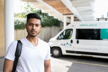 Man stood in front of a community ambulance